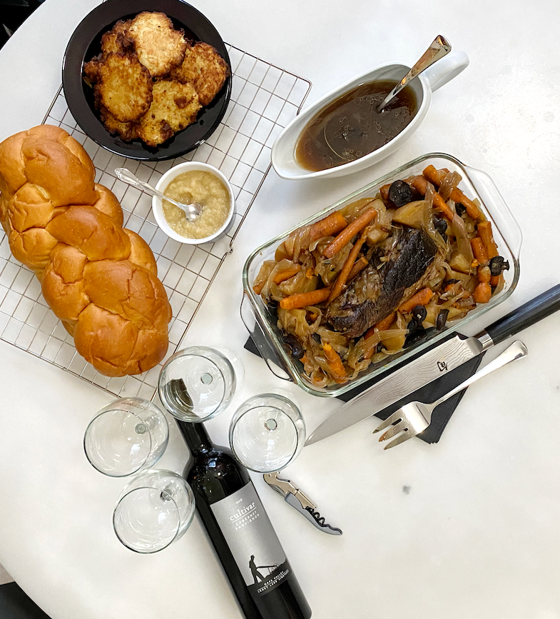 The perfect Chanukah brisket with a bottle of wine and challah 
