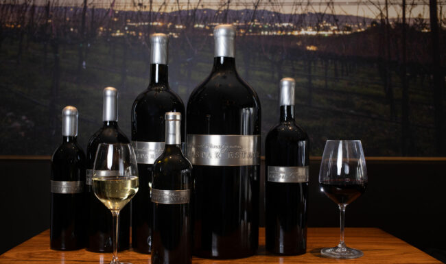 Caspar Estate bottles and a glass of wine