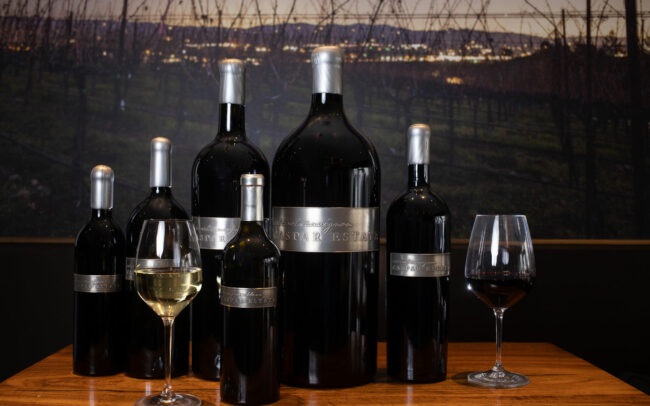 Caspar Estate bottles and a glass of wine