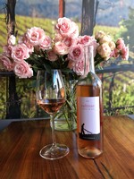 Bottle of 2017 Rosé with a bouquet of pink roses