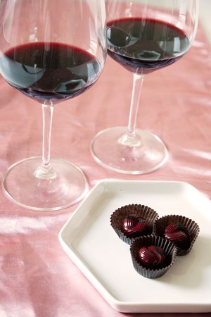 Two glasses of Cultivar red wine with chocolates