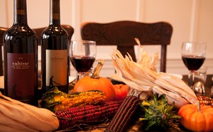 Thanksgiving table settings with bottles of wine