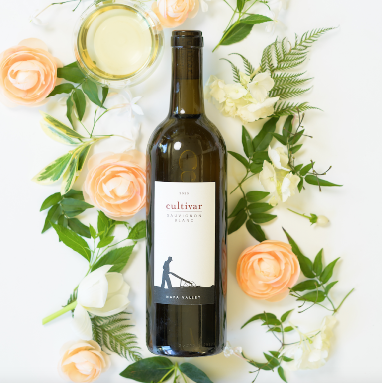 Bottle of Cultivar wine with flowers around it