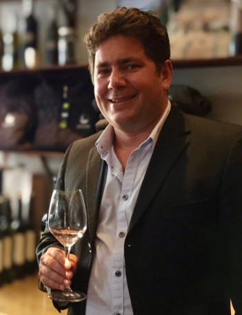 Winemaker Julien Fayard holding a glass of wine