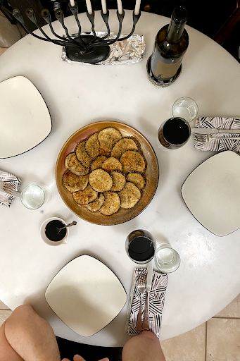 Breaded eggplant on a set table for Chanukah