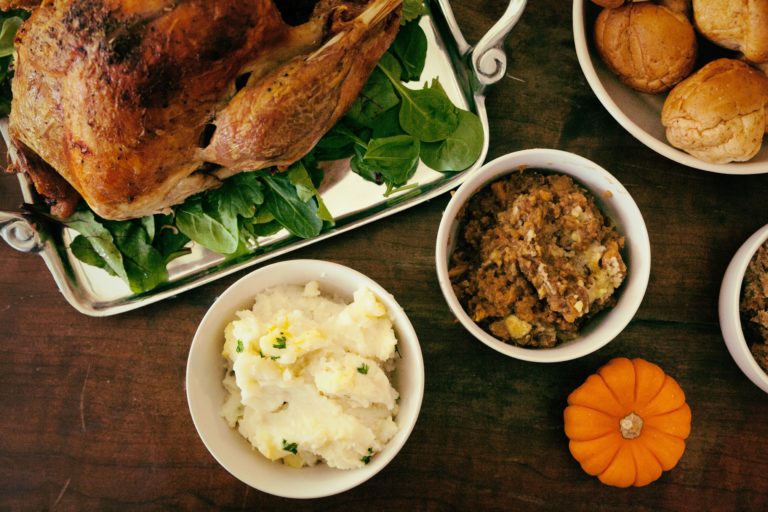 Turkey with mashed potatoes, stuffing, and dinner rolls